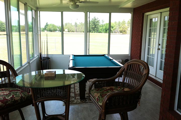Sunroom that effectively extended the house includins air conditioning, a pool table and enough space for chairs, recliners and even a little bar. Built in Mississipi, MS