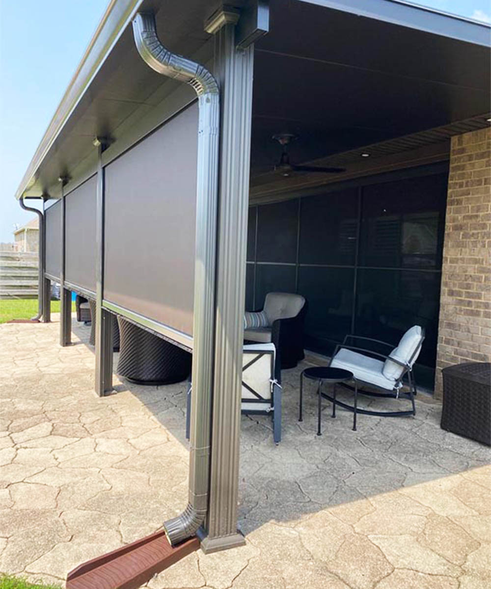 Motorized retractable screen housing, side tracks, and screen fabric integrated with a covered patio
